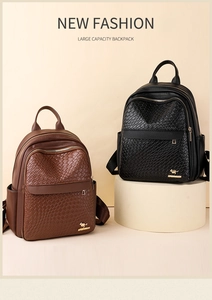 Detail of woven texture and gold kangaroo logo on large capacity faux leather backpack