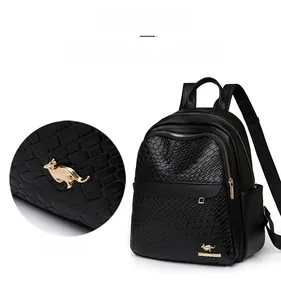 Close-up of black crocodile-embossed leather texture with golden kangaroo logo detail