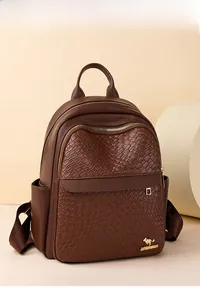 Detailed view of dark brown leather backpack featuring woven texture and golden logo