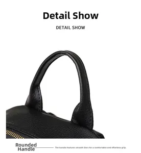 Detail view of the soft black pebble leather handle and golden zipper on the backpack