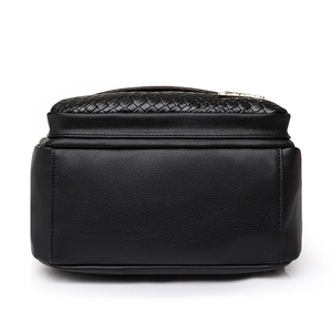 Black leather backpack with woven top texture and gold logo in minimalist design