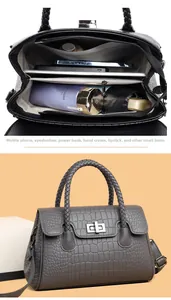 Macro view of textured crocodile embossed tote bag with spacious interior compartments