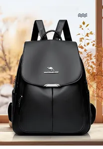 Detail of black pebbled leather backpack featuring a secure metal buckle flap and brand logo