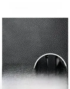 Macro shot of durable black litchi grain leather texture and inner zipper detail of the bag