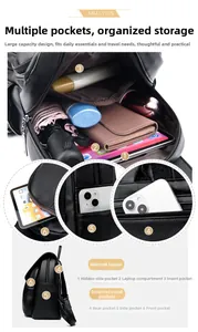Detailed view of the black leather backpack interior showing laptop sleeve and multi-pockets