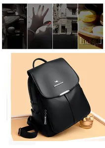 Close-up of black lychee grain leather backpack with metal kangaroo logo and zipper detail