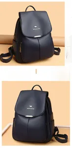 Detail of navy blue pebble leather backpack with metal kangaroo logo and flap closure