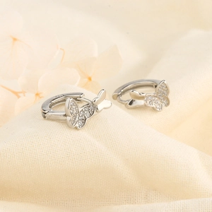 Macro shot of S925 silver double butterfly earrings with cubic zirconia inlay detail