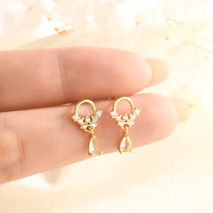 Detailed close-up of gold water drop earrings with sparkling zircon crystals for women