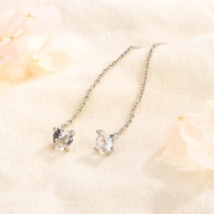 S925 sterling silver tassel earrings with heart-shaped cubic zirconia on a soft fabric