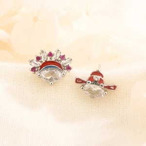 Macro detail of asymmetric Peking Opera earrings with red enamel and sparkling cubic zirconia