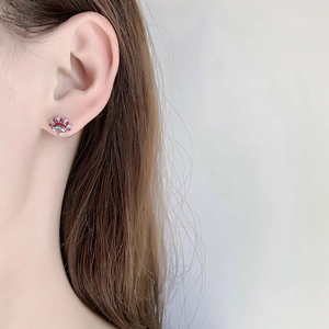 Detail of Peking Opera style earring with colorful crystals on a model's ear