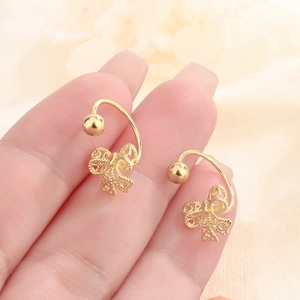 Detailed close-up of golden hollow lace bow earrings with elegant screw-back design