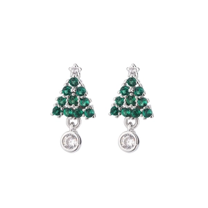 Close-up of Christmas tree drop earrings with green cubic zirconia and star detail