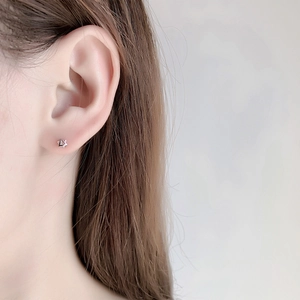 Minimalist sterling silver hexagonal star stud earring shown on female ear model