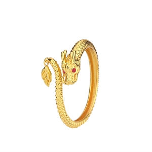 Macro shot of 14K gold-plated dragon ring with red gem eyes and scale texture detail
