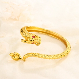 Adjustable 14K gold plated dragon bangle with red gemstone eyes and scale texture