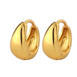 Detailed view of chunky golden teardrop hoop earrings with polished metallic finish