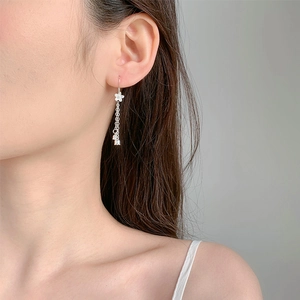 Detailed view of silver S925 lily of the valley earrings with tassel drop on a model