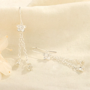 Detailed macro view of S925 silver lily of the valley earrings with hanging tassels