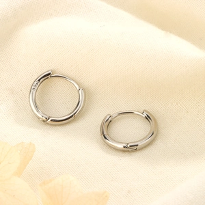 Detailed close-up showing the S925 sterling silver hallmark on minimalist hoop earrings