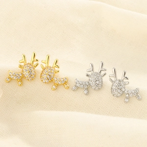 Detailed view of gold and silver reindeer stud earrings with shimmering zircon stones