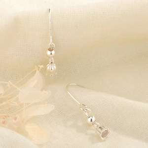 Elegant S925 silver lily of the valley drop earrings on soft fabric background