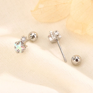 Detailed macro view of star stud earring with colorful stone and screw-back ball closure