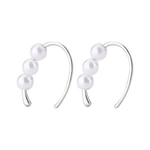 Close-up of C-shaped silver hook earrings featuring three elegant white pearls