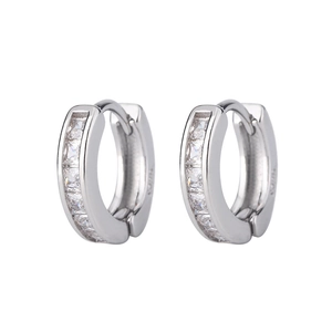 Close-up of silver huggie earrings with five square-cut cubic zirconia in channel setting