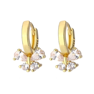 Macro shot of gold bow earrings featuring pear-cut cubic zirconia and S925 silver stamp