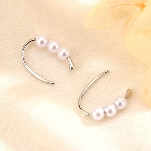 Minimalist silver-tone U-shape drop earrings featuring three elegant white pearls