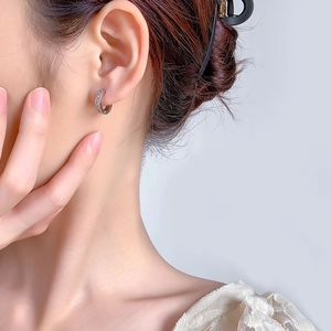 Classic silver hoop earrings with micro-pave crystals on a model for minimalist style