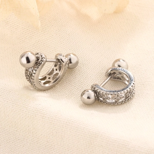 Detail view of S925 silver curved screw back earrings with micro-set zircon and hollow design