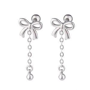 Close-up of silver bow earrings with long tassel chains and screw-back ball closures