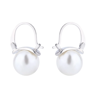 Detail of elegant white round pearl drop earrings with minimalist silver metal hooks