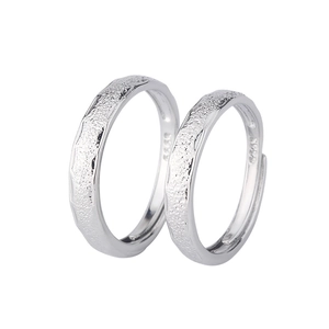 Macro view of S925 sterling silver couple rings with textured hammered matte finish