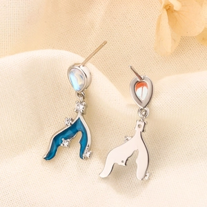 Detailed close-up of S925 silver mermaid tail earrings with moonstone and blue enamel