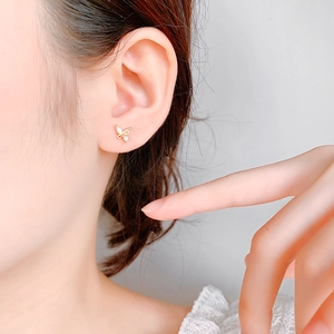 Elegant gold S925 silver butterfly earrings with pink cubic zirconia on female model