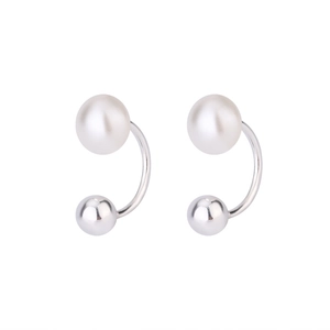 Detail of C-shaped freshwater pearl earrings with silver metallic ball in minimalist style