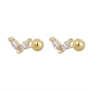 Macro detail of gold piercing studs with marquise-cut zircons and ball screw backs