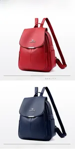 Detail view of large capacity pebbled leather backpacks in red and blue with metal logo
