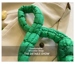 Detail of bright green quilted padded shoulder strap on a stylish nylon tote bag