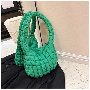 Detailed close-up of quilted neon green cloud tote bag fabric with secure zipper closure
