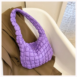 Detail view of purple quilted puffer cloud bag with textured padding and square stitch design