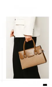 Detail of woven texture and smooth brown leather on a professional tote handbag