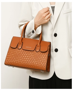 Close-up of brown woven leather tote with double handles and Balado & Bag logo