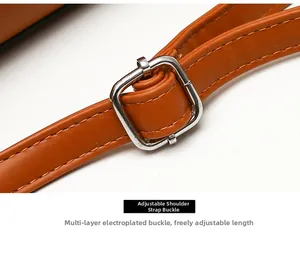 Macro detail of brown leather shoulder strap with silver adjustable metal buckle
