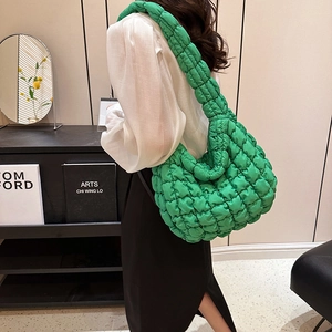 Quilted grass green hobo bag with padded cloud texture and wide shoulder strap