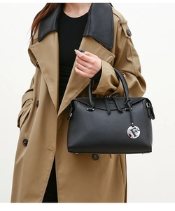 Détail du sac à main en cuir grainé noir avec pendentif F et doubles poignées